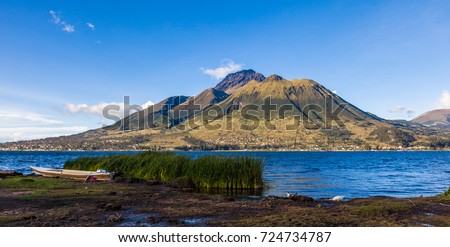 Panorama of Imbabura volcano, with blue sky and  San Pablo Lake