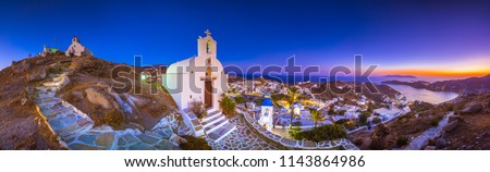 Panorama of Ios Chora and old harbor at sunset, Cyclades, Greece.