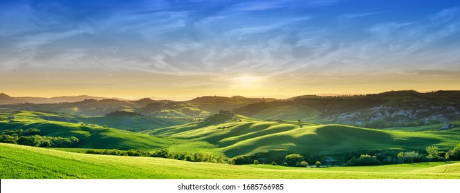 Panorama, Italian beautiful landscape, green rolling Tuscan fields in warm light of the setting sun - Shutterstock ID 1685766985