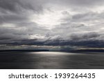 Panorama of the lake before the rain. Thunderclouds over the lake.