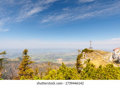 Panorama of Lake Chiemsee with summit cross of mountain Hochfelln