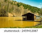 Panorama of the lake and green forest with fir trees in the park in summer in spring. Blue sky. with reflection in water. Park "Red Key" in Russia. Bashkiria. People Walking in the Park