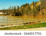 Panorama of the lake and green forest with fir trees in the park in summer in spring. Blue sky. with reflection in water. Park "Red Key" in Russia. Bashkiria. People Walking in the Park