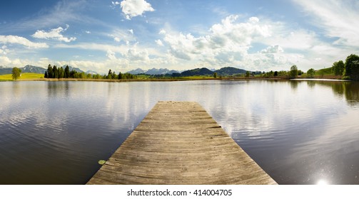 panorama landscape in Bavaria with lake and wooden swimming pier - Powered by Shutterstock