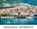 Panorama and landscape of Makarska resort and its harbour with boats and blue sea water