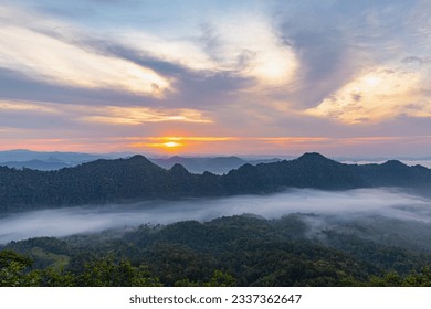 Panorama landscape with of stunning view in early morning with sunrise and fog over the big mountains, View point from the top of Doi Fah Ngam (Fah Ngam Mountain) Chae Hom District, Lampang, Thailand.