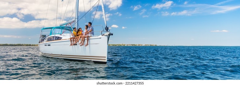 Panorama Of Latin American Mother And Father With Young Children Enjoying Carefree Travels On Luxury Family Vacation Sailing Private Yacht