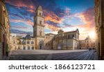 Panorama of Lecce, Puglia, Italy at sunset. Piazza del Duomo square, Campanile tower and Virgin Mary Cathedral (Basilica di Santa Maria Assunta in Cielo), Caritas Diocesana. Baroque city of Apulia