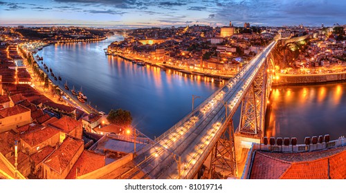 Panorama of lighted  famous bridge Ponte dom Luis above  Old town Porto and  river Duoro at night, Portugal