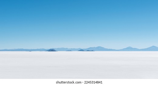 Panorama of lost islands in a sea of salt, Uyuni salt flat desert, Bolivia.