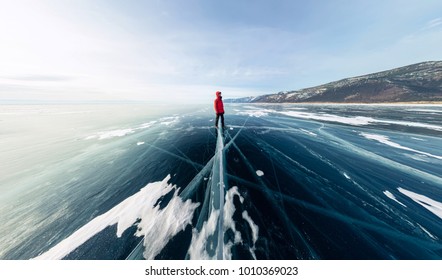 Panorama Man Stand On Cracks On Blue Ice Of Lake Baikal From Olkhon.