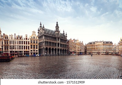 Panorama of the Market Square or Grand Place in Brussels in autumn rainy weather in autumn orange tones with wet paving stoness, Belgium