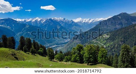 Panorama of meadow in Kullu valley in Himalaya mountains in spring. Himachal Pradesh, India