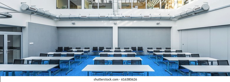 Panorama Of Modern College Study Hall In Blue And Grey With Tables And Desks