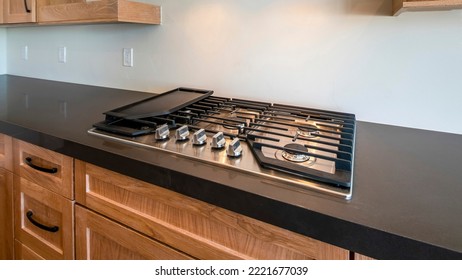 Panorama Modern Craftsman Kitchen Counter With Gas Cooktop With Griddle And Custom Vent Hood Insert. Kitchen With Black Counter With Natural Wood Drawers And Cabinets Below The Floating Shelves