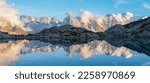 The panorama of Mont Blanc massif  Les Aiguilles towers and Grand Jorasses over the Lac Blanc lake in the sunset light.