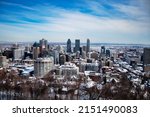 Panorama of Montreal city from Mount Royal Park during winter, snow covered buildings