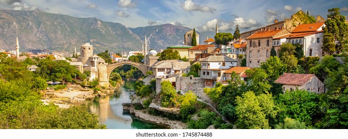 Panorama Mostar bridge in Bosnia and Herzegovina. Colorful landscape in the city of Mostar with a bridge and an emerald mountain river. panoramic