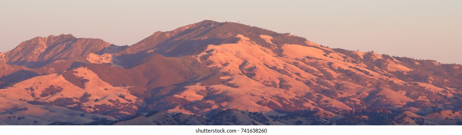 Panorama of Mount Diablo as setting sun glows on the mountain