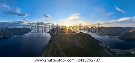 Panorama of Mount Segla with surrounding mountains and fjord in the midnight sun