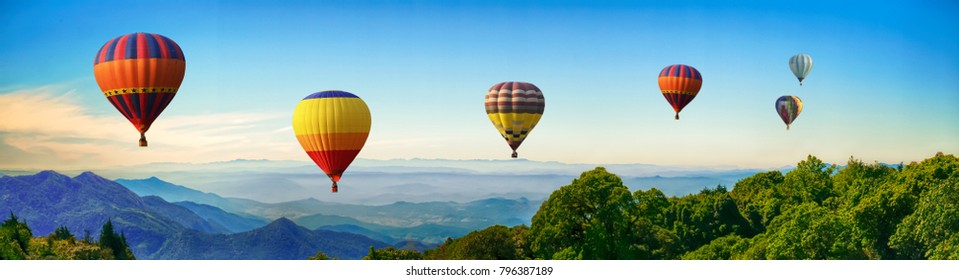 Panorama of mountain with hot air balloons on morning at Thailand.