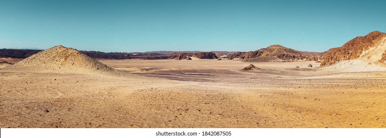 Panorama Of Mountain Landscape With Stone Desert And Sandy Ground, No People. Nature Background For Your Safari Tour In Egypt, Travel In Africa, Extreme Adventures Or Science Expedition.