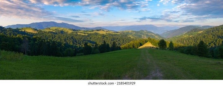 Panorama Of Mountain Landscape In Summertime. Countryside Scenery With Rural Fields On The Forested Hills Rolling In To The Distant Valley. Borzhava Ridge Beneath A Stunning Morning Sky