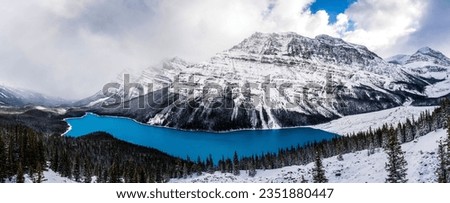 Panorama of a mountain river in the snowy mountains. Winter snow mountain river. Mountain river on winter snow panorama. Snowy mountain river panoramic landscape