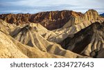 panorama of the mountains in golden canyon during the spring sunrise; the famous coloured mountains which can be seen from zabriskie point; hiking in golden canyon in death valley national park	