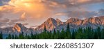Panorama of Mountains illuminated by sunset in Kananaskis Country, Alberta. The mountain park is a destination for outdoor activities including hiking and wildlife viewing in the Canadian Rockies
