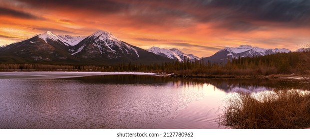 Panorama of Mountains illuminated by sunset in Banff National Park. The vermillion lakes, a destination for outdoor activities like paddling and seeing wildlife in the canadian rockies