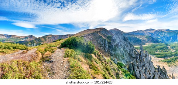 Panorama with mountains landscape, rocks, dry grass and blue sky - Shutterstock ID 1017224428