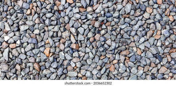 Panorama of Multi-colored pebbles floor pattern and background seamless