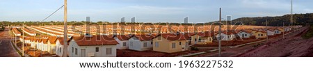 Panorama of a neighborhood with many identical popular houses built by the government housing program