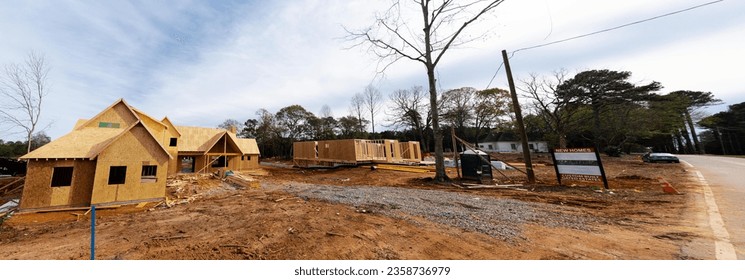 Panorama new development house OSB Oriented Strand Board plywood sheathing roofing, timber frame post beam under construction suburbs Atlanta, Georgia, USA. Suburban American residential building - Shutterstock ID 2358736979