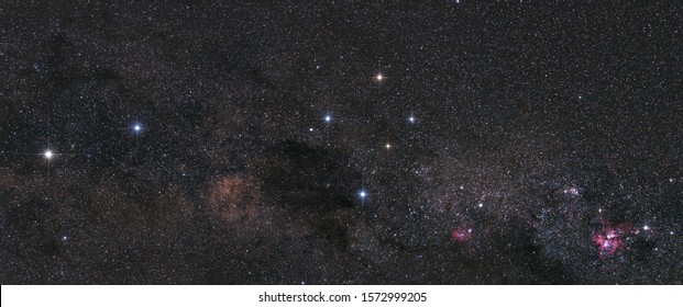 Panorama od the southern hemisphere night sky with the the Southern Cross, the Centaurus pointer stars, and the Eta Carinae nebula - Shutterstock ID 1572999205
