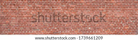 Panorama of an old red brick wall as a background or texture