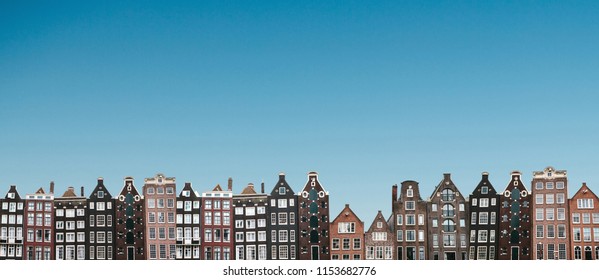 Panorama or panoramic view. Traditional houses in Amsterdam in the Netherlands in a row against the blue sky.