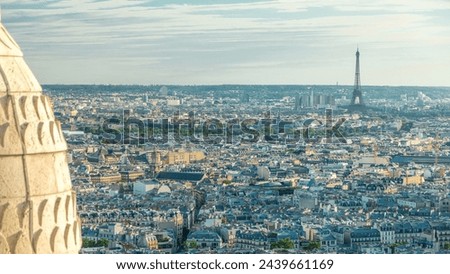 Panorama of Paris from above timelapse with Eiffel tower, France. Aerial top view over city streets from Montmartre viewpoint. Sunny day with blue cloudy sky.