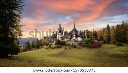 Panorama of Peles Castle, Romania. Beautiful famous royal castle and ornamental garden in Sinaia landmark of Carpathian Mountains in Europe at sunset. Former Home Of The Romanian Royal Family. 