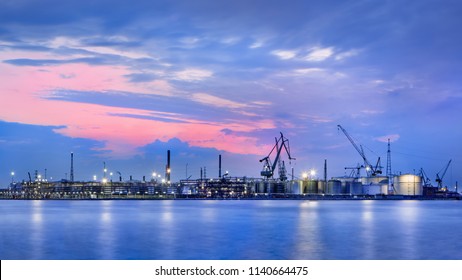 Panorama Of A Petrochemical Production Plant Against A Dramatic Colored Cloudy Sky At Twilight, Port Of Antwerp, Belgium.