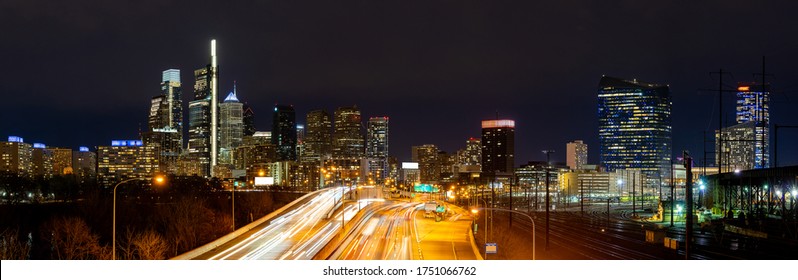 Panorama Of Philadelphia Skyscraper Skylines Building At Night Illuminated With Highway Urban Road Transportation In Philly City Downtown Of Philadelphia In PA USA. Cityscape Urban Lifstyle Concept.