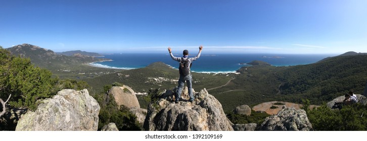 Panorama photo of the back of the hiker who climbed to the top of a rock in Wilson promontory Melbourne Australia - Shutterstock ID 1392109169