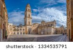 Panorama of Piazza del Duomo square , Campanile tower and Virgin Mary Cathedral (Basilica di Santa Maria Assunta in Cielo), Caritas Diocesana in Lecce - Puglia, Italy. Baroque city of Apulia 