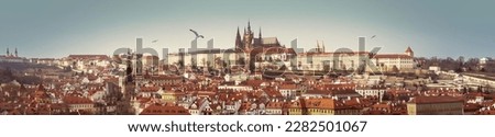 Panorama of Prague Castle with Gothic Cathedral of st.Vitus on skyline. Wide city landscape of Praga, view on Petrin Hill, Hradcany area and buildings with red tiles roofs. Banner for travel agency.