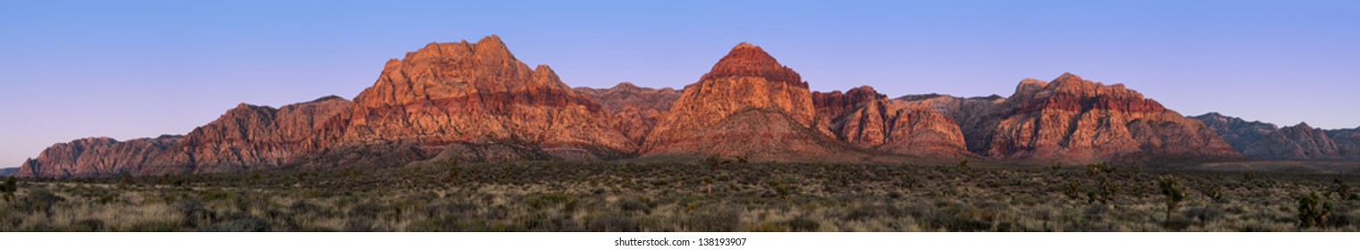 Panorama Of Red Rock Canyon, Nevada, USA, At Sunrise With Yucca And Joshua Trees In The Foreground