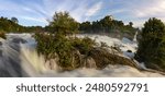 Panorama of Rhinefalls - the biggest waterfall in Europe - in high water season with Castle Laufen on the hill top (long exposure)