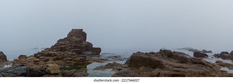 Panorama of rock formation at the sea in the fog on a hazy mystic autumn morning in Sillon de Talbert area, Brittany, France - Powered by Shutterstock