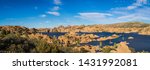 Panorama of the rugged beauty of Watson Lake in Prescott Arizona.  This reservoir is surrounded be weathered cliffs of the Granite Dells and blear blue skies.