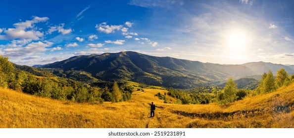 panorama of rural landscape in carpathian mountains in autumn. sunny day. grassy field and rolling hills. countryside scenery of ukraine. village in the distant valley - Powered by Shutterstock